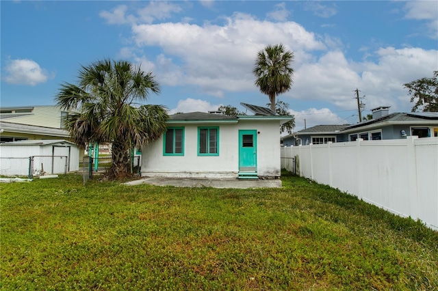 rear view of property featuring a yard