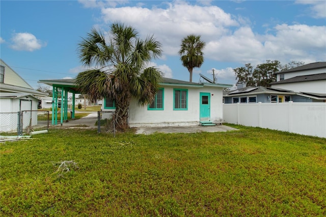 rear view of house featuring a yard