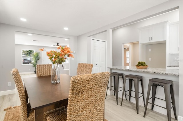 dining space featuring ceiling fan and light wood-type flooring