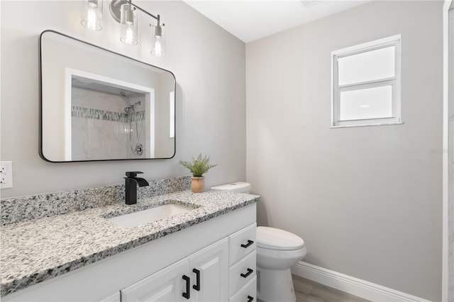 bathroom featuring vanity, toilet, and a shower