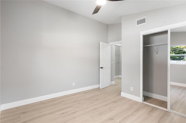 unfurnished bedroom featuring light hardwood / wood-style flooring, a closet, and ceiling fan