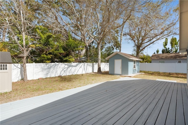 wooden terrace with a storage unit and a yard