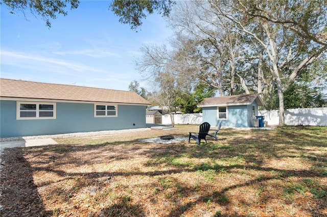 exterior space featuring a fire pit and a storage unit