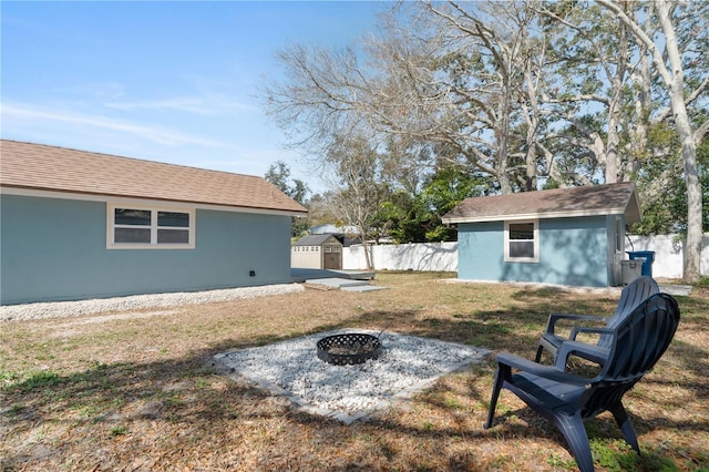 view of yard with a fire pit and a shed