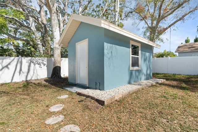 view of outdoor structure featuring a lawn