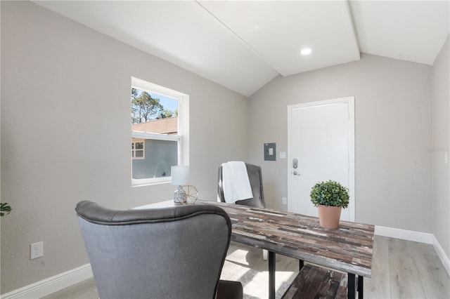 home office featuring vaulted ceiling and light hardwood / wood-style flooring