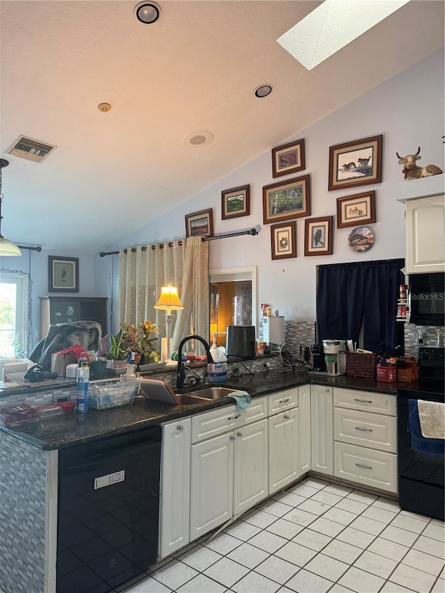 kitchen featuring black / electric stove, light tile patterned floors, white cabinets, and vaulted ceiling with skylight