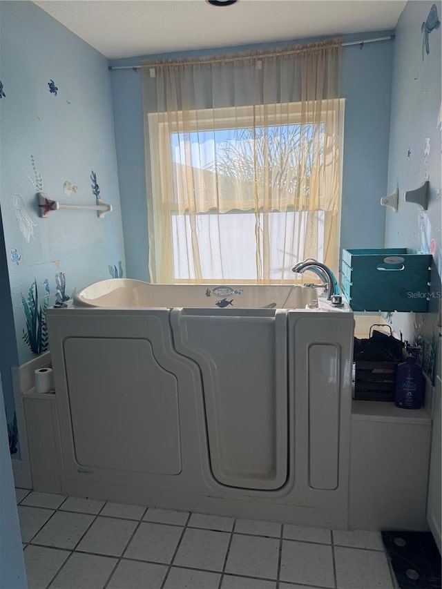 washroom featuring light tile patterned flooring and a wealth of natural light