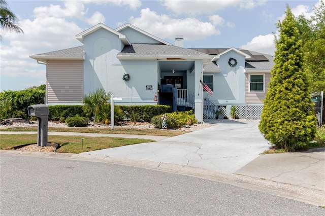 5771 Catskill Rd, Holiday, FL 34690 - view of front facade featuring driveway and solar panels