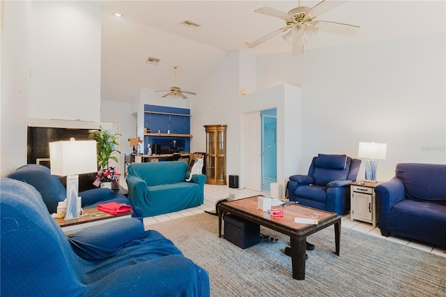5771 Catskill Rd, Holiday, FL 34690 - living room with high vaulted ceiling, visible vents, a ceiling fan, and light tile patterned flooring