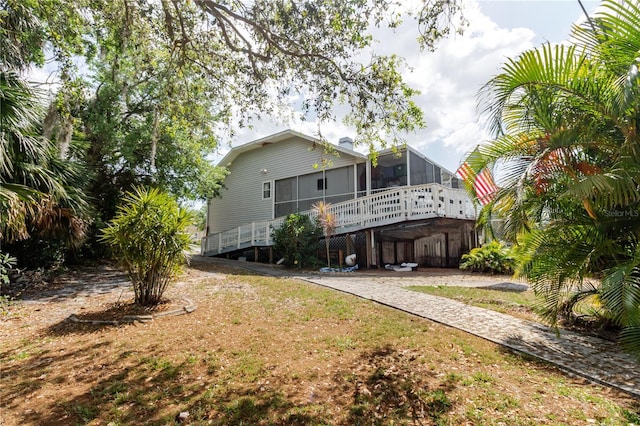 5771 Catskill Rd, Holiday, FL 34690 - rear view of house with a sunroom