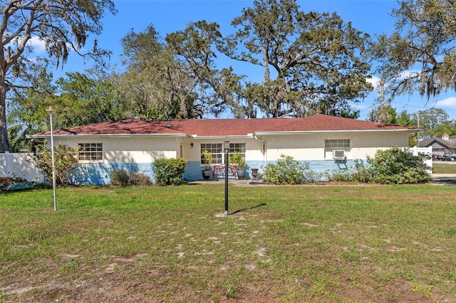 view of front of home with a front yard and stucco siding