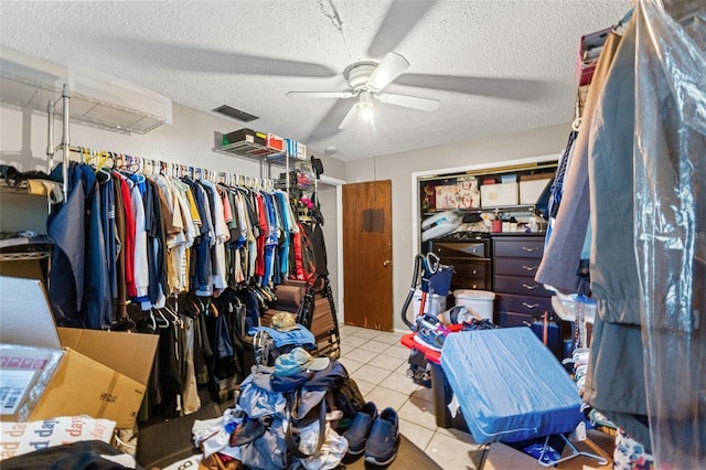 spacious closet with ceiling fan, light tile patterned flooring, and visible vents