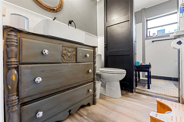 bathroom with toilet and wood finished floors