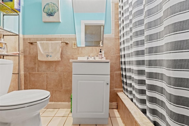 full bathroom with tile patterned flooring, tile walls, toilet, and vanity