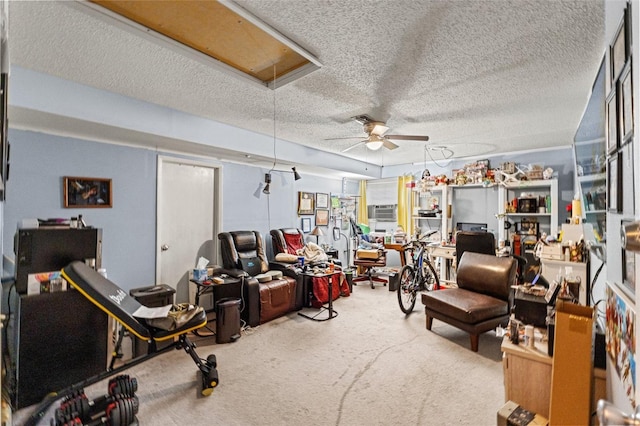 interior space featuring carpet floors, a wall mounted air conditioner, ceiling fan, and a textured ceiling