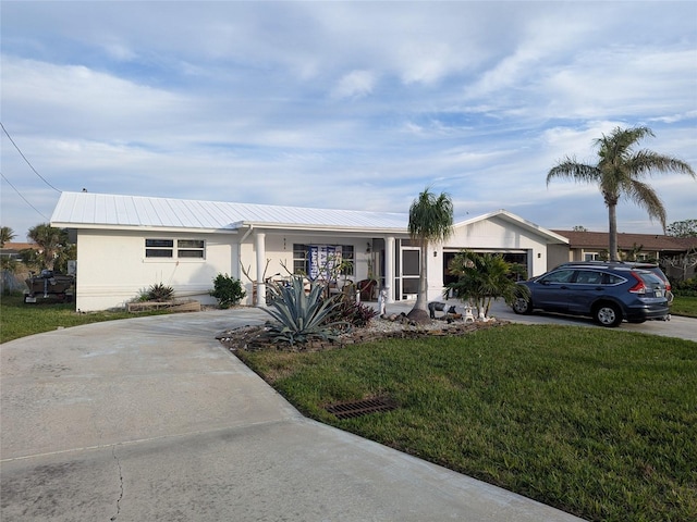 ranch-style home with a garage and a front lawn