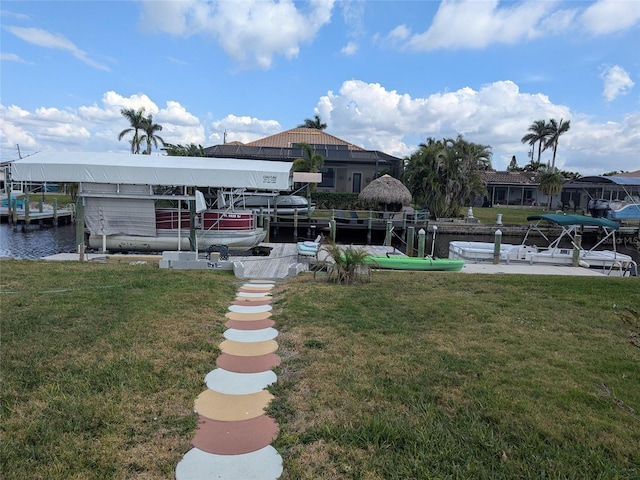 dock area featuring a water view and a lawn