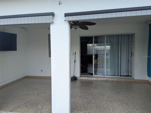 view of exterior entry with ceiling fan