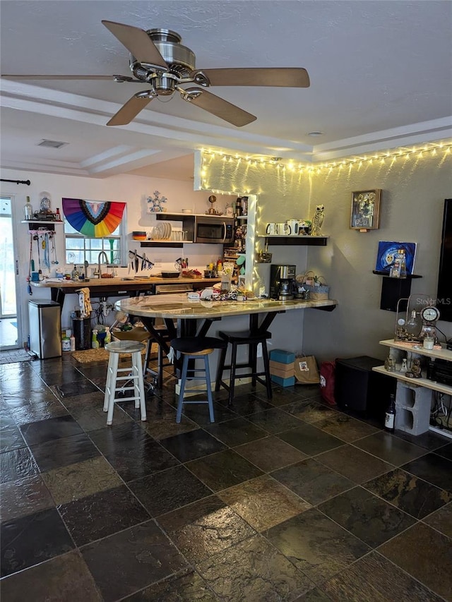 dining room featuring sink and ceiling fan