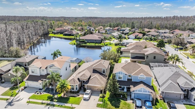 birds eye view of property with a residential view, a forest view, and a water view