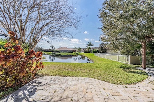 view of yard featuring a water view and fence