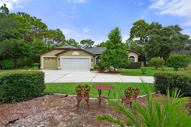 view of front of house with a garage and a front yard