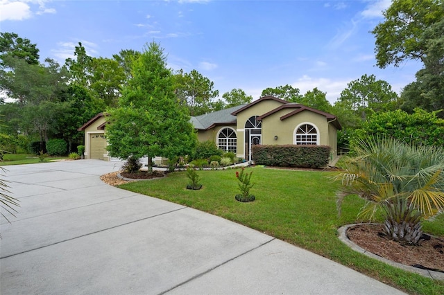 view of front of house with a garage and a front lawn