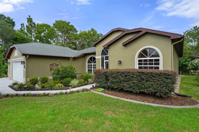 view of front of house with a garage and a front lawn