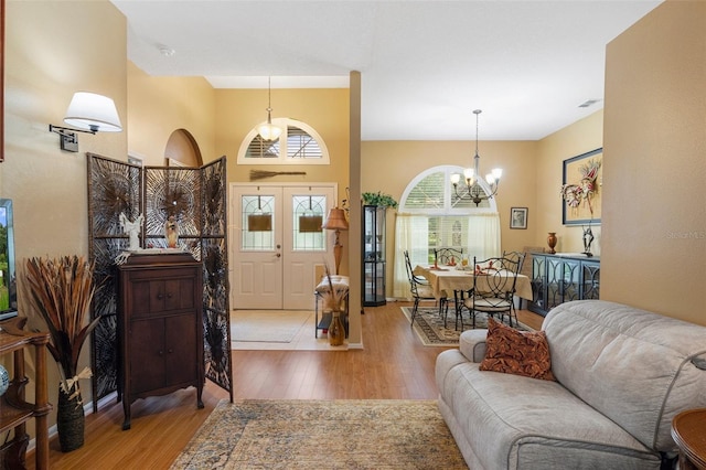 interior space featuring an inviting chandelier and light wood-type flooring