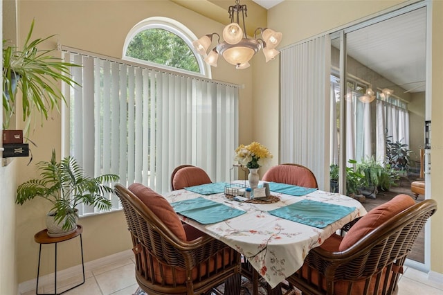 dining area featuring a notable chandelier and light tile patterned floors