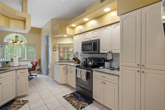 kitchen featuring light tile patterned flooring, light stone countertops, tasteful backsplash, and range with electric stovetop