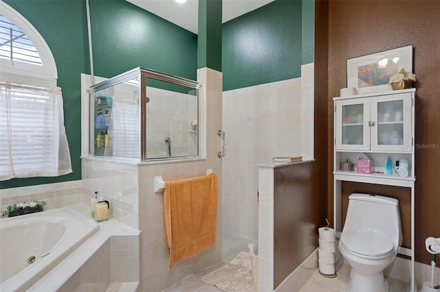 bathroom with independent shower and bath, tile patterned flooring, and toilet