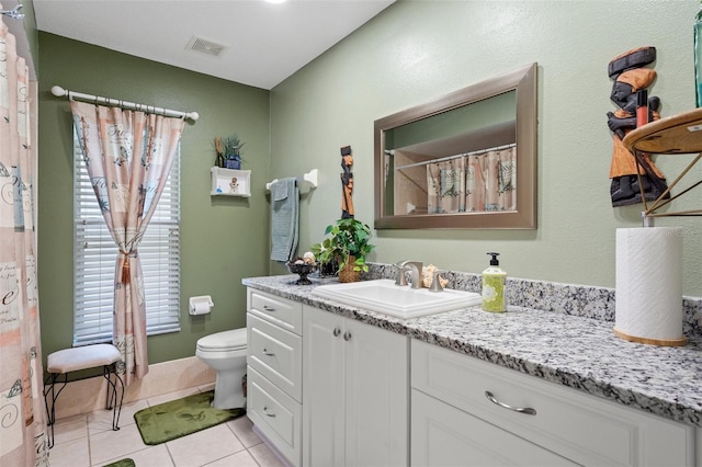 bathroom featuring vanity, tile patterned floors, and toilet