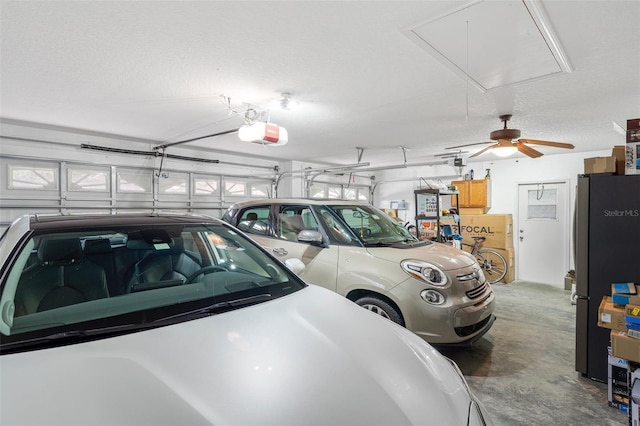 garage featuring a garage door opener and stainless steel fridge