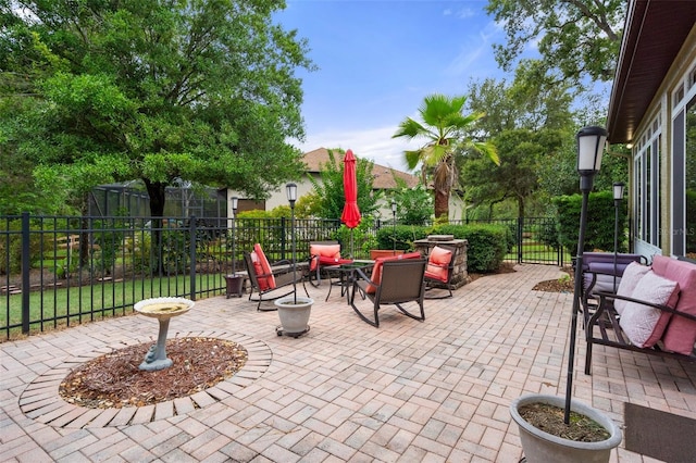 view of patio featuring an outdoor living space with a fire pit