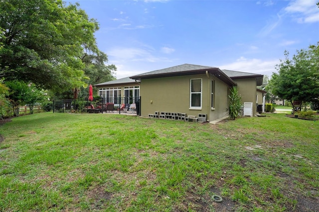 back of property featuring a lawn