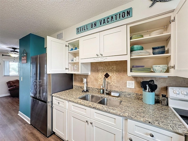 kitchen featuring white cabinetry, sink, electric range, light stone countertops, and a textured ceiling