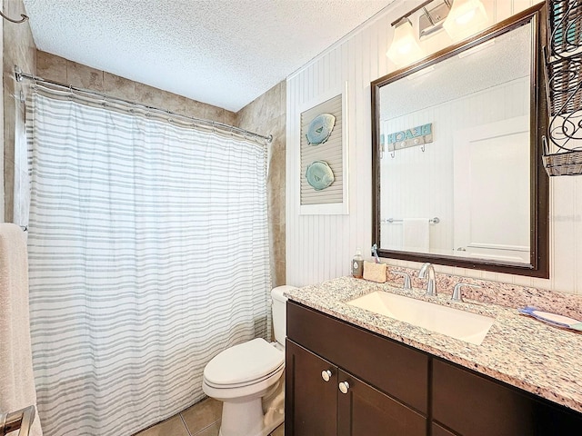 bathroom featuring tile patterned flooring, a shower with shower curtain, vanity, a textured ceiling, and toilet