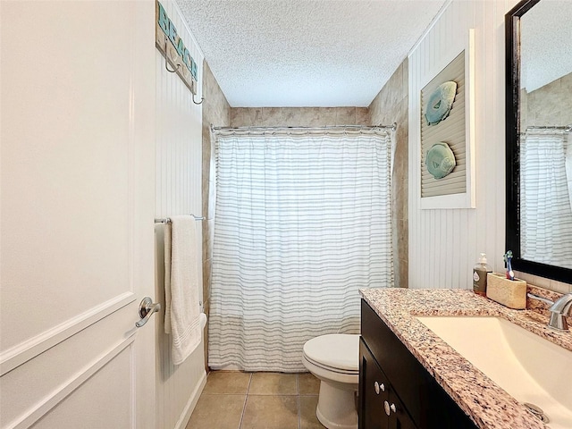 full bathroom featuring tile patterned floors, toilet, a textured ceiling, and vanity