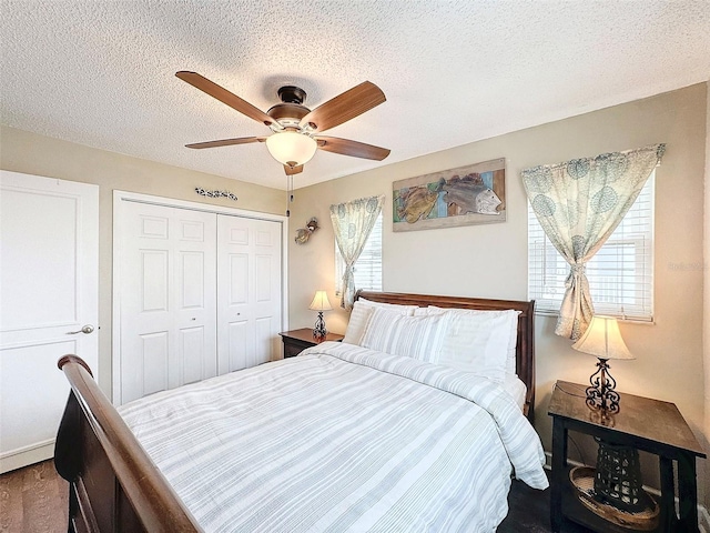 bedroom with ceiling fan, a closet, and a textured ceiling