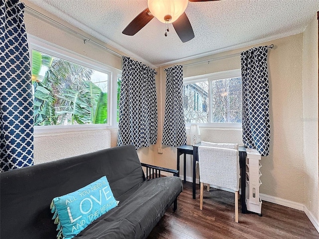 sitting room with hardwood / wood-style floors, a textured ceiling, and ceiling fan