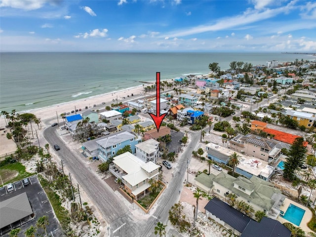 birds eye view of property with a view of the beach and a water view