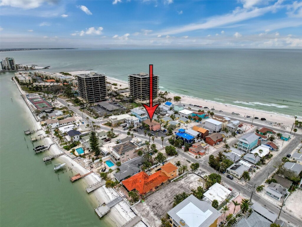 birds eye view of property featuring a water view, a view of the beach, and a view of city