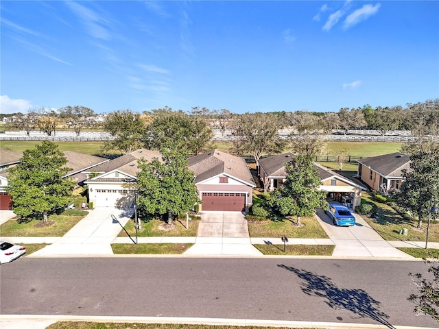 view of front of property with a garage, driveway, and a residential view