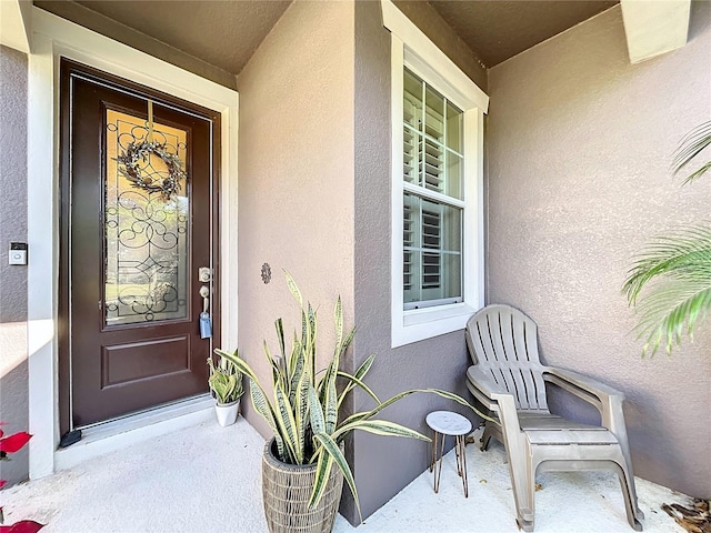 entrance to property with stucco siding