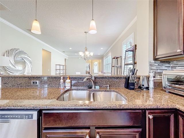 kitchen with light stone counters, pendant lighting, a sink, and stainless steel dishwasher