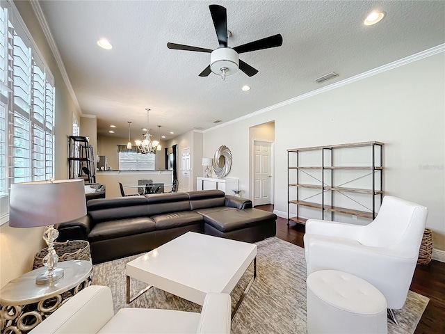 living area with dark wood-style floors, recessed lighting, visible vents, and crown molding