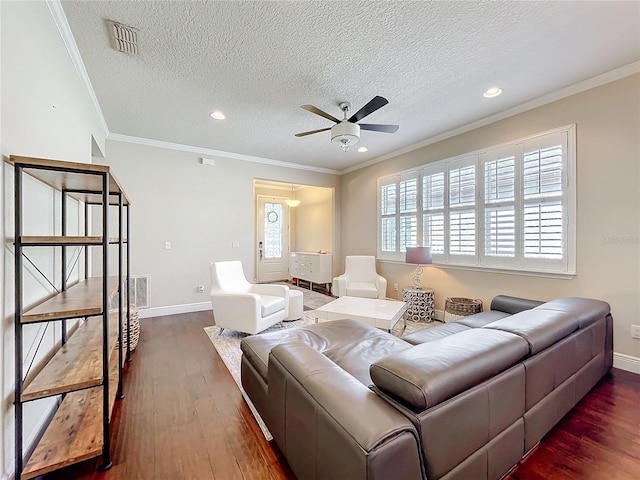 living area with ceiling fan, visible vents, baseboards, ornamental molding, and dark wood-style floors