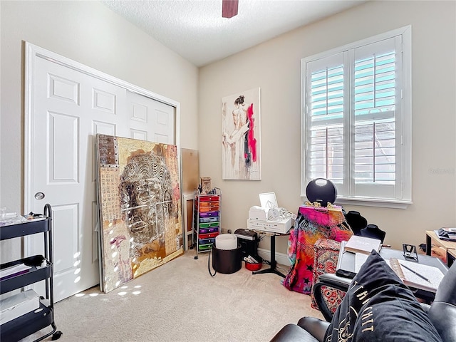 game room with a textured ceiling, carpet, and a ceiling fan